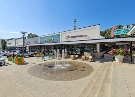 A fountain in the middle of a plaza in front of a shopping center at Elme Druid Hills, Atlanta, Georgia