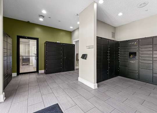 A room with a green wall and a row of black lockers at Elme Druid Hills, Atlanta, Georgia