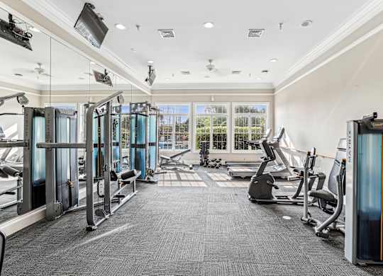 A gym with treadmills, elliptical machines, and other exercise equipment at Elme Dulles, Herndon, VA