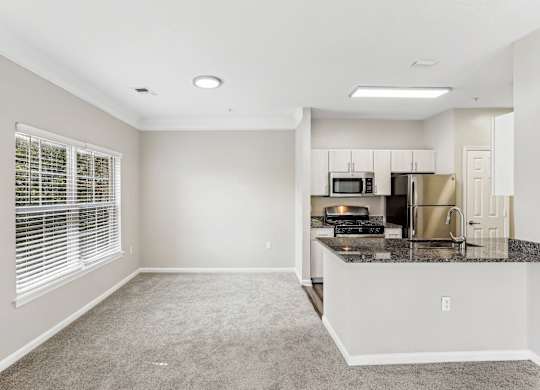 A kitchen with a microwave, oven, and refrigerator at Elme Dulles, Herndon, VA