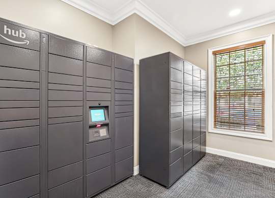A row of Amazon lockers are lined up in a room.