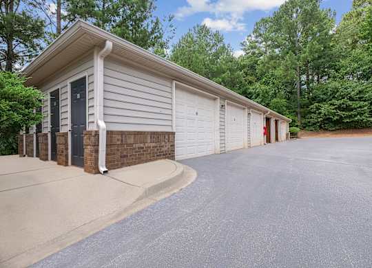 A two-car garage with a brick pillar and a black door.