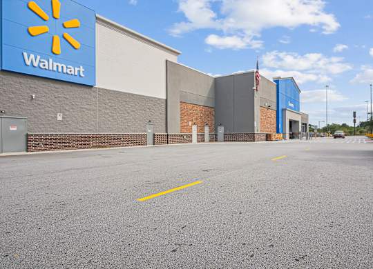 A Walmart store with a blue and yellow sign on the side.