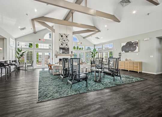 A modern living room with a large rug and a dining table.