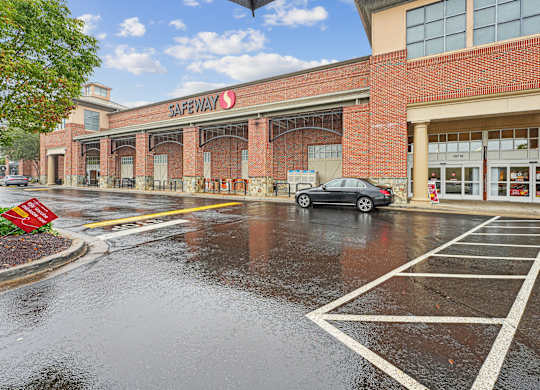 Safeway store with a car parked in front.