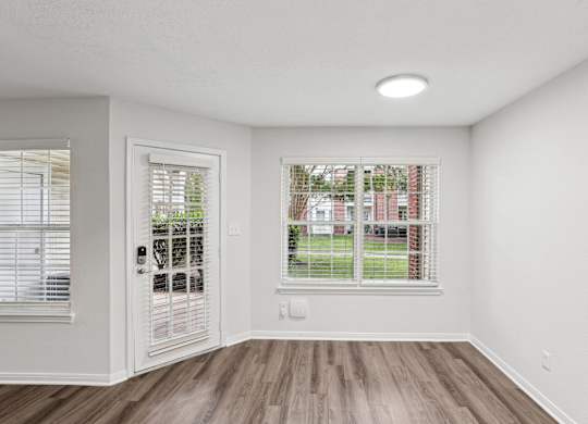 A room with a window and a door.