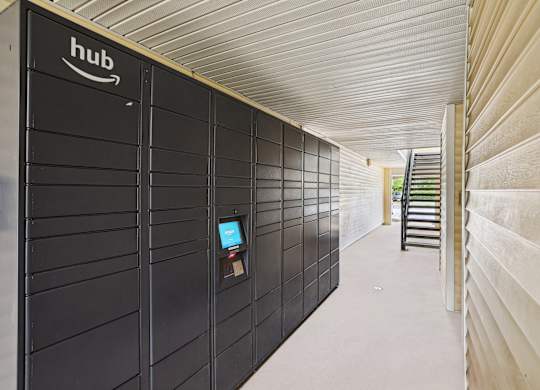 A long hallway with a row of Amazon storage units on the left.