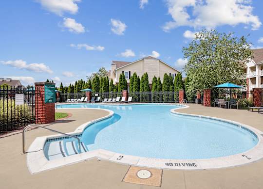 A pool with a slide and a sign that says