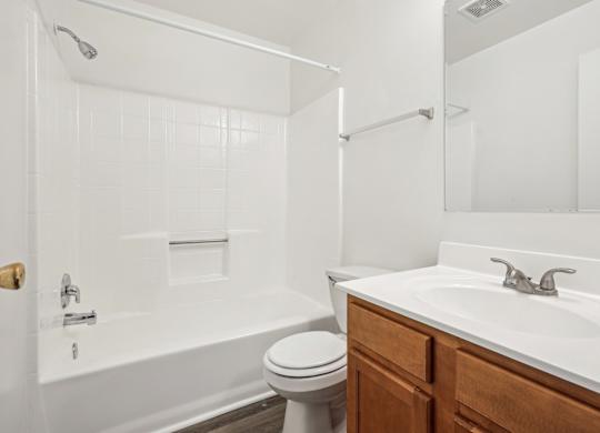 A white bathroom with a toilet, sink, and bathtub at Elme Leesburg, Virginia, 20176