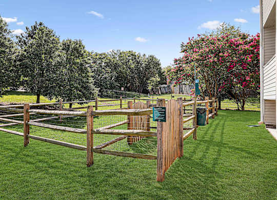 A wooden fence encloses a green lawn.