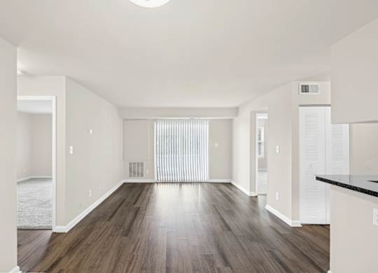 A spacious room with wooden floors and white walls at Elme Leesburg, Virginia, 20176