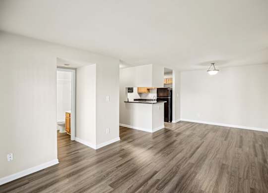 A room with wooden flooring and white walls at Elme Leesburg, Virginia, 20176