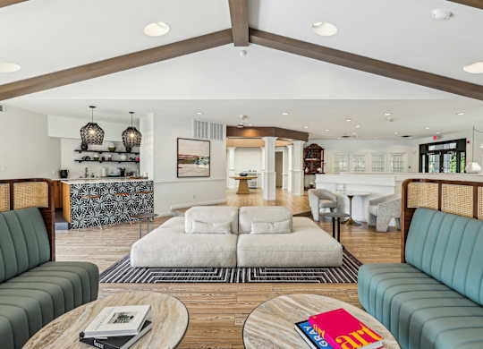 A living room with a white couch and a wooden coffee table at Elme Manassas, Manassas, 20109