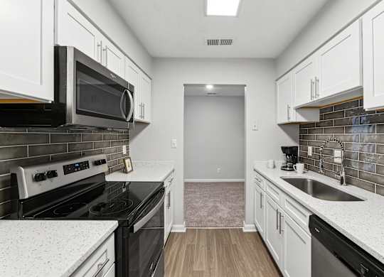 A kitchen with black appliances at Elme Sandy Springs Apartments, Atlanta, GA, 30350