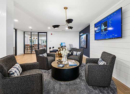 A modern living room with a grey sofa, a black coffee table at Elme Sandy Springs Apartments, Atlanta, GA, 30350