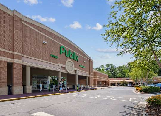 A large building with a green sign that says