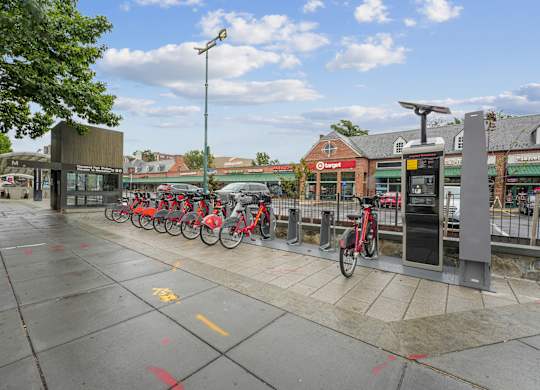 A row of bikes are parked at a bike station.