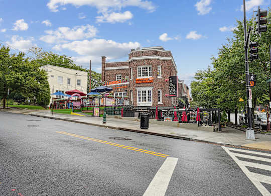 A city street with a crosswalk and traffic lights.
