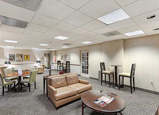 A conference room with a table, chairs, and a couch.