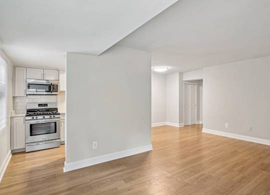 A spacious room with wooden flooring and white walls The Kenmore, Washington, 20015