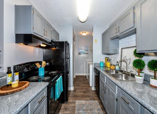 Kitchen with wood cabinets and black appliances