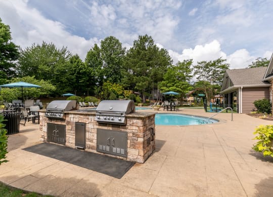 Grilling station and pool at Elme Marietta Apartments, Marietta, GA