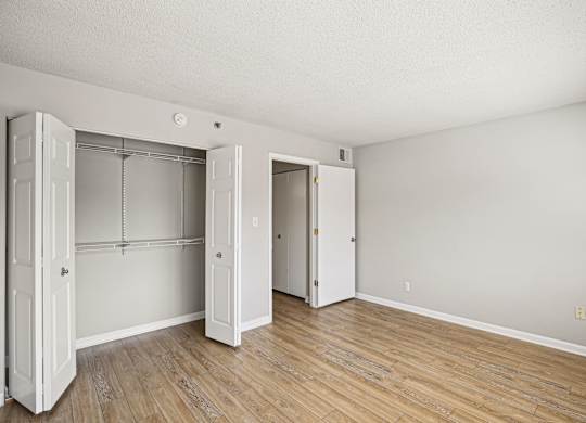A room with a white door and a wooden floor  at The Paramount, Arlington, Virginia