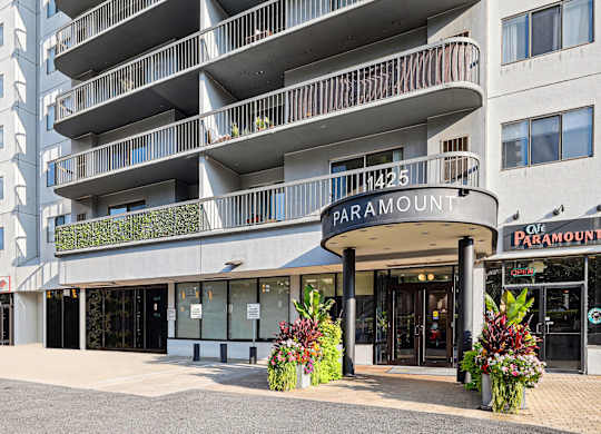 A Paramount building with a balcony and a sign.