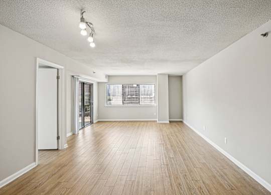 A room with wooden floors and a window.