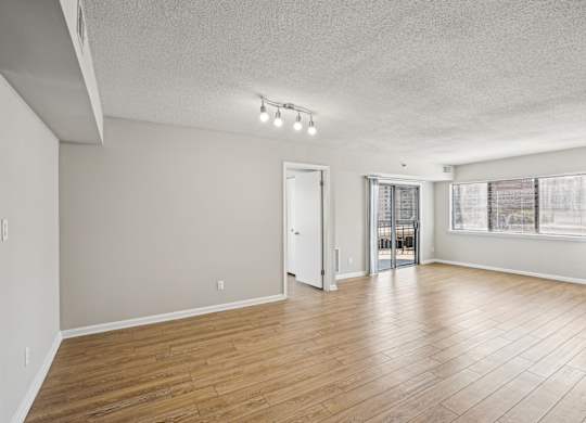 A room with wooden flooring and white walls  at The Paramount, Arlington, Virginia