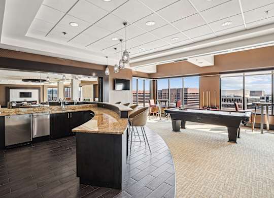 A modern kitchen with a pool table.
