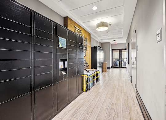 A long hallway with a black wall on the left and a wooden floor  at The Paramount, Arlington, Virginia