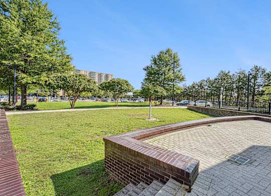 A park with a brick wall and a grassy area at Riverside Apartments, Alexandria, Virginia