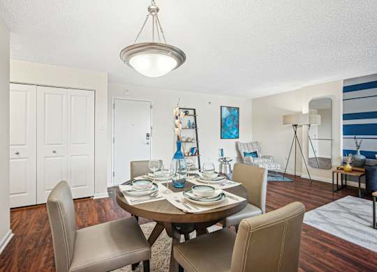 A dining room with a table set for a meal at Riverside Apartments, Alexandria, Virginia