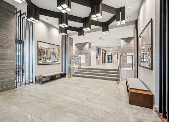 A hallway with a staircase and a painting on the wall at Riverside Apartments, Alexandria, Virginia