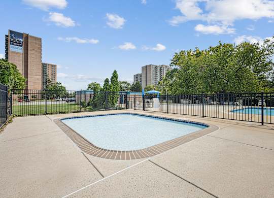 A small pool surrounded by a black fence at Riverside Apartments, Alexandria, Virginia