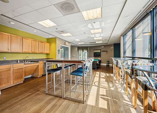A long row of bar stools are lined up in a room at Riverside Apartments, Alexandria, Virginia