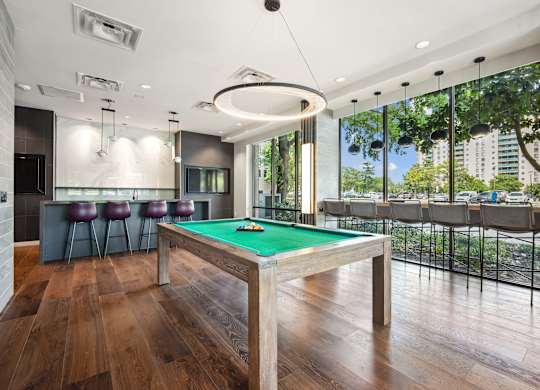 A billiard table in a room with a bar and a balcony at Riverside Apartments, Alexandria, Virginia