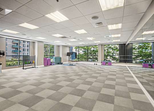 A spacious room with a checkered floor and large windows at Riverside Apartments, Alexandria, Virginia