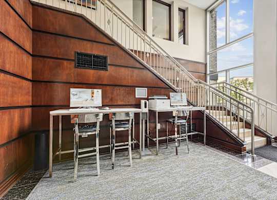 A staircase with a table and chairs on the landing  at Roosevelt Towers, Falls Church, VA