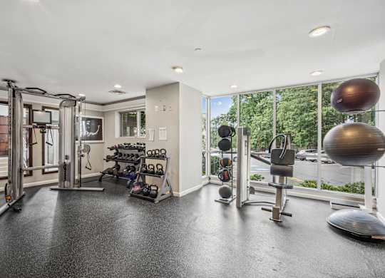 A spacious home gym with a variety of exercise equipment  at Roosevelt Towers, Falls Church, VA