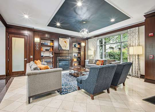 A living room with a grey couch and a grey chair at Roosevelt Towers, Falls Church, VA