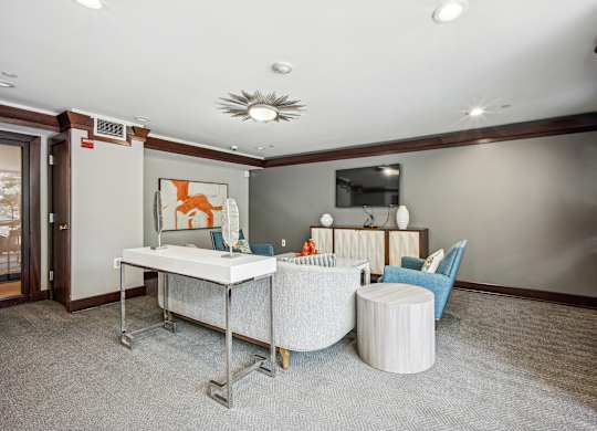 A room with a white desk and blue chairs  at Roosevelt Towers, Falls Church, VA