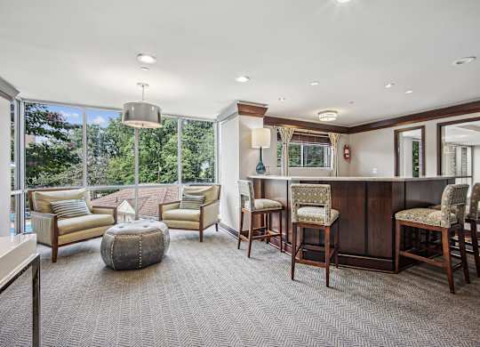 A well-lit room with a bar and comfortable seating  at Roosevelt Towers, Falls Church, VA