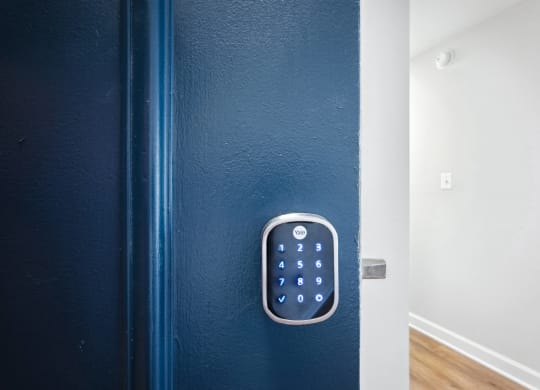 Blue door with smart lock at Roosevelt Towers Apartments, Falls Church, Virginia