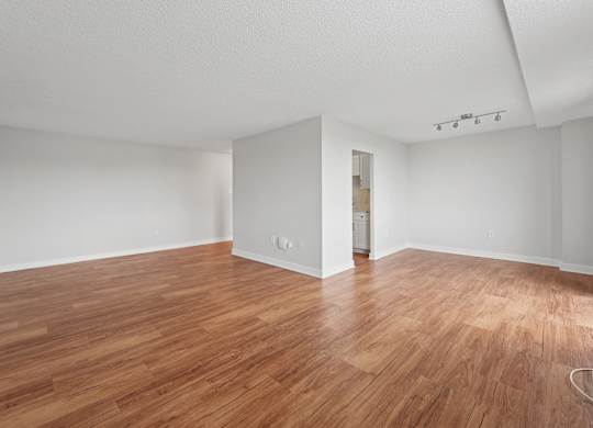 A room with wooden flooring and white walls  at Riverside Apartments, Alexandria, Virginia