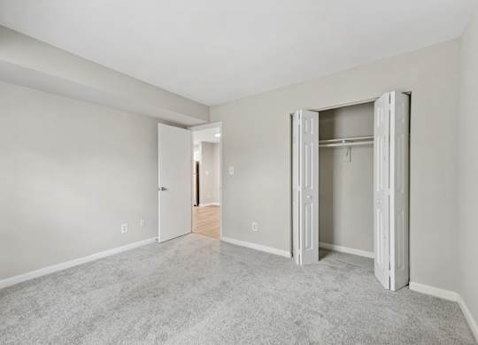 A room with a carpeted floor and white walls.