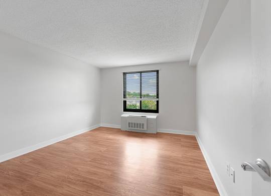 A room with a window and a radiator on the floor  at Riverside Apartments, Alexandria, Virginia