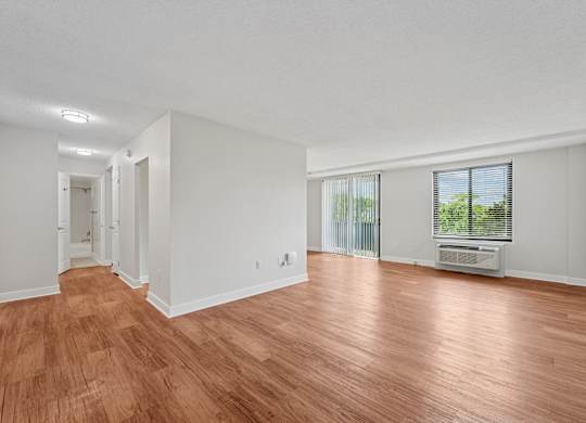 A room with wooden flooring and white walls  at Riverside Apartments, Alexandria, Virginia