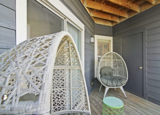 a porch with a white chair and a hammock at Elme Druid Hills, Atlanta, Georgia